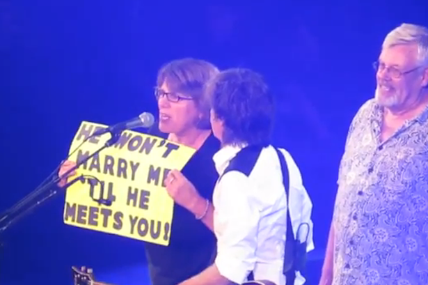 A couple has an on stage proposal after meeting Paul McCartney