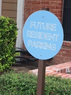A sign indicates a parking spot for future residents