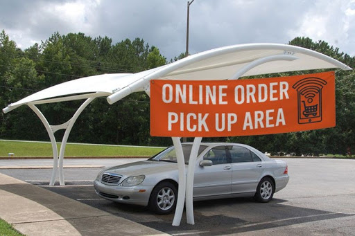 A large banner indicates a space for cars to drive up and pick up online orders