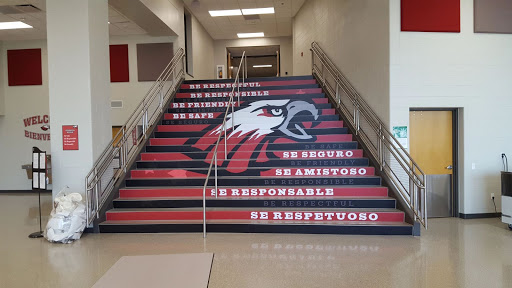 A staircase is decorated with the school mascot and quotes