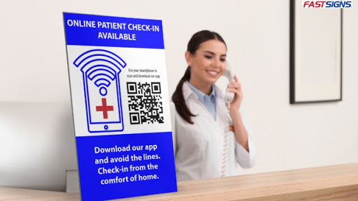 A sign presents a touchless option for patients to check in by using a QR code