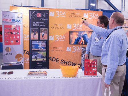 Attendees engage with a booth at a trade show