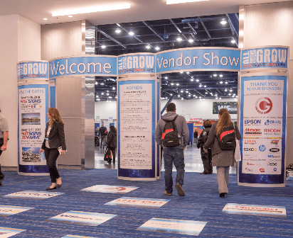 The entrance for a trade show has prominent signage to draw attention