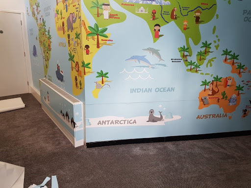 A wall has graphics applied to show a map of the world