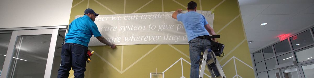 two men hanging a banner