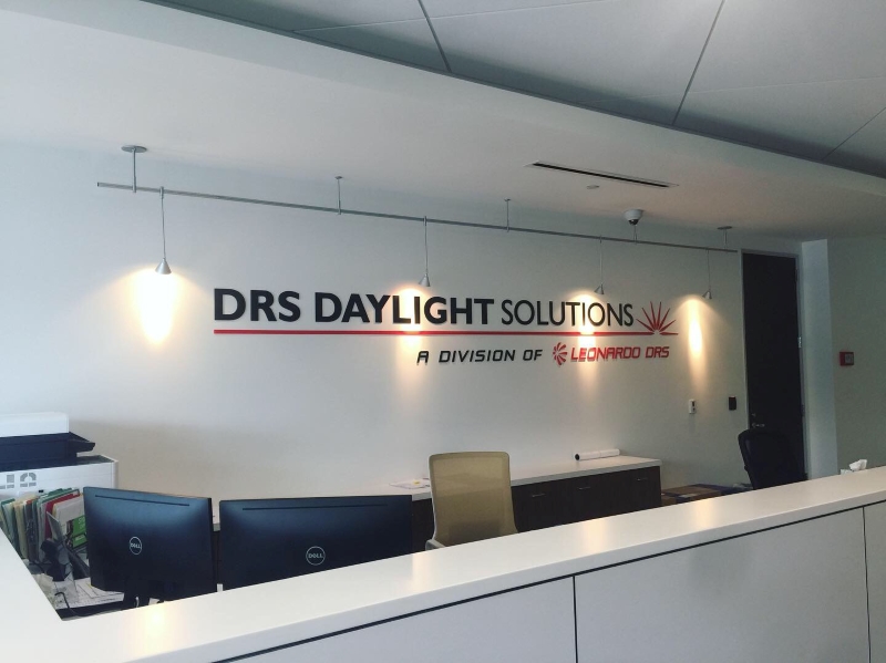 DRS Daylight Solutions Signage Behind Desk
