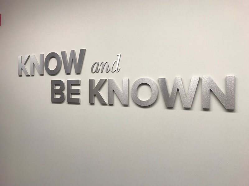 A metal wall sign with letters that read “Know and Be Known,” installed by FASTSIGNS in an office building in Las Vegas, Nevada