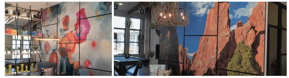 One apartment wall with a colorful Fastsigns wall and another wall with tall red rocks and a tree