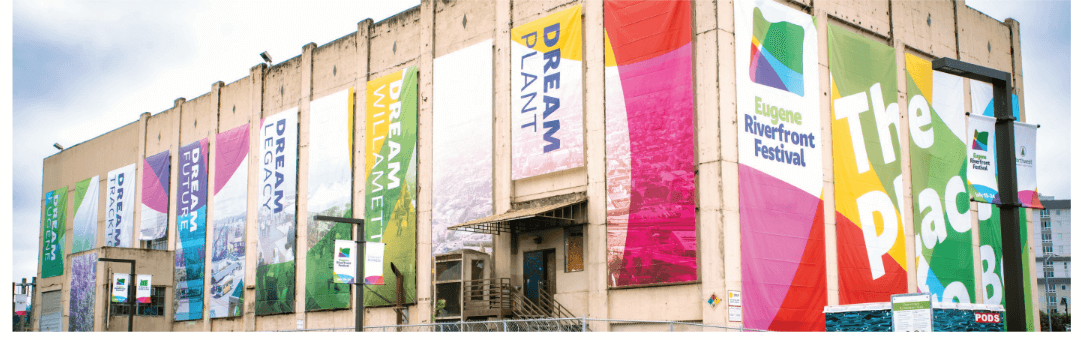 building with colorful draped signs