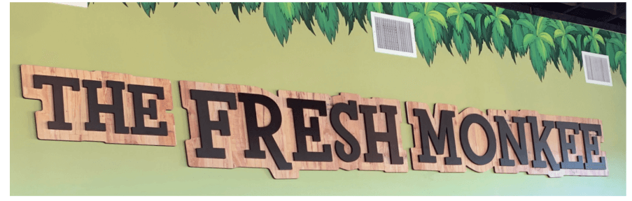 green wall with wood signage