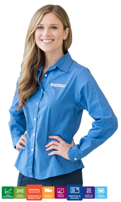 female FASTSIGNS employee wearing blue long sleeve button up shirt