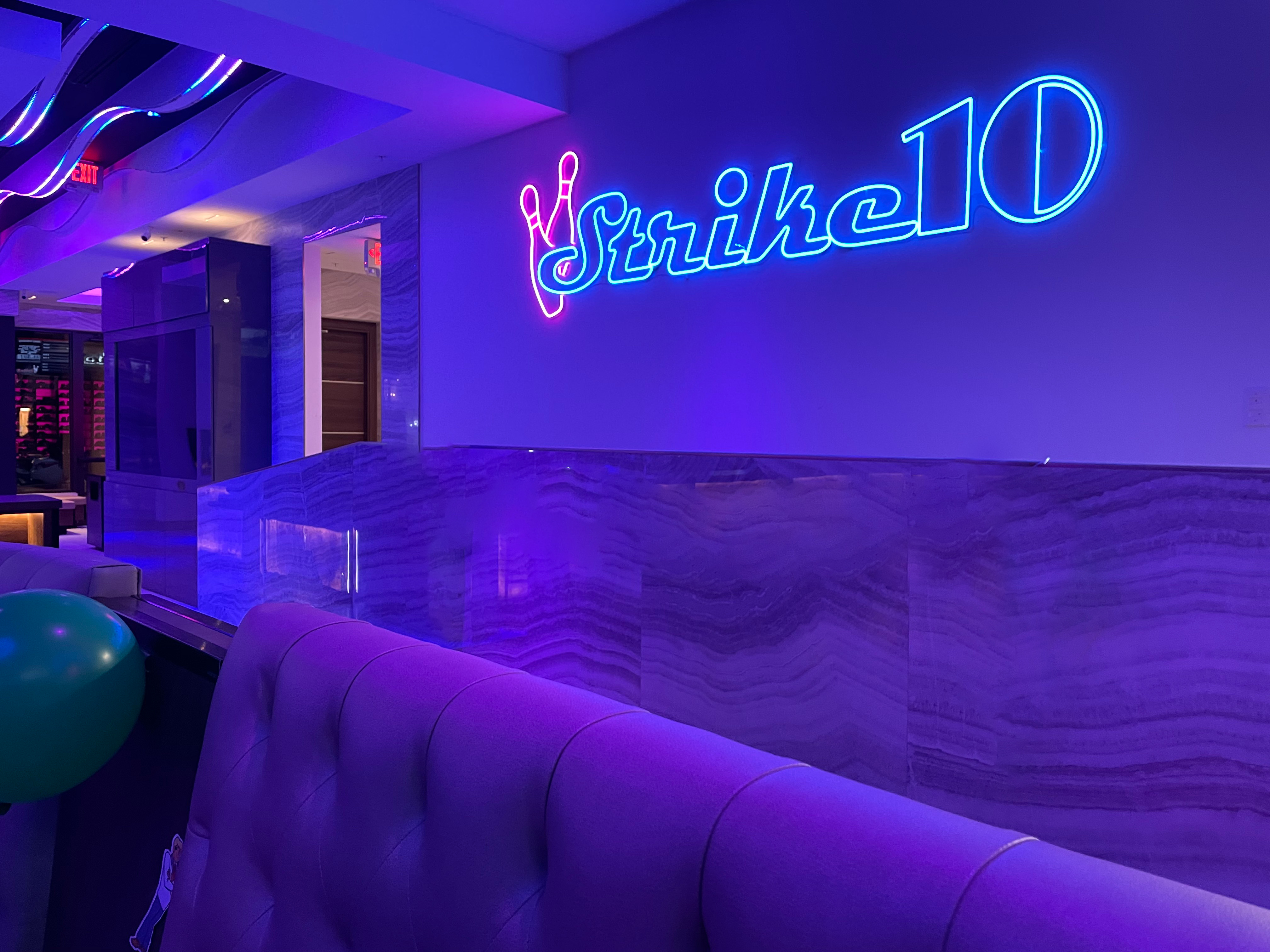 lit up signage in a bowling alley