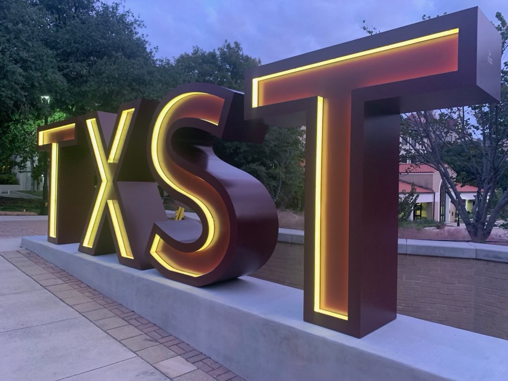 a large sign that reads TSXT