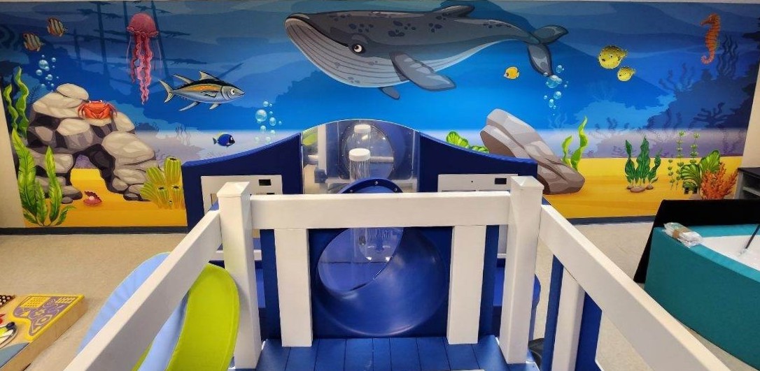 sensory room with an ocean mural on the wall
