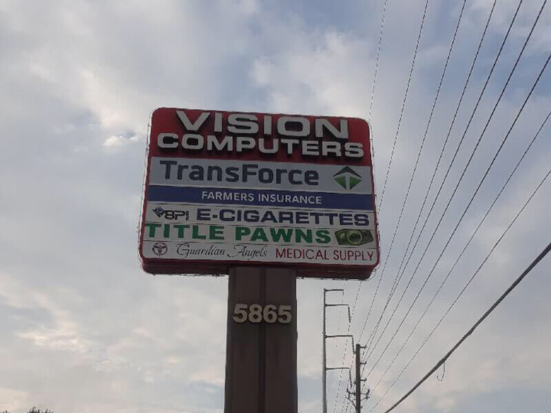 Different business names on the pylon pole with number address