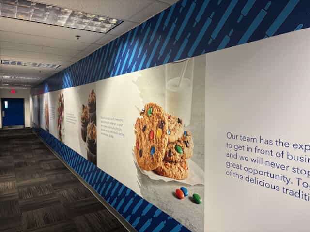 An image of a wall graphic of milk and cookies and company information made by FASTSIGNS.