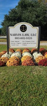 Sarvis Law Signage with details on orange and white flowers 