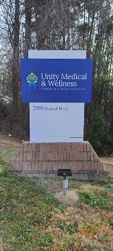 Unity Medical & Wellness signage with trees as a background