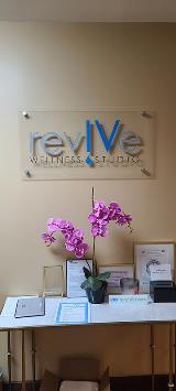 Revive custom decal with certificates and pink flower on the table