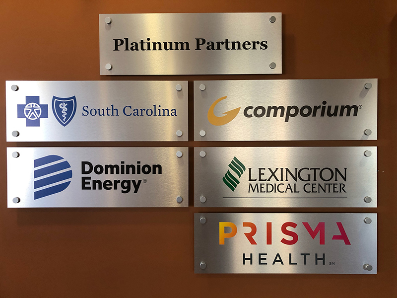 Different custom logos on the brown wall