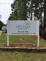 Retreat at broad river apartment signage with numbers on the side of the road with fast sign van on the back