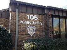 105 Public safety signage with logo on the brick wall