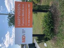 MD VIP medical signage with plants on the side 