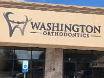 Washington Orthodontics signage with logo on the building