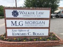 three business name signage on the middle of the parking lot