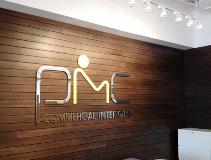 PMC Commercial interiors signage on the wood wall