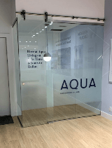 Aqua sign on the glass door of the office