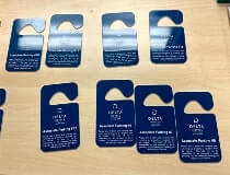 Door hanging signs of delta hotels on the table