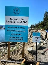 Post and panel directional signage on the beach