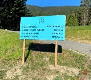 Okanagan beach club wayfinding signage on the side of the road