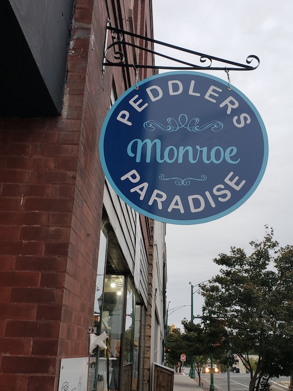 Business name hanging sign on the building