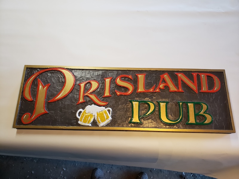 Prisland Pub custom sign on the table