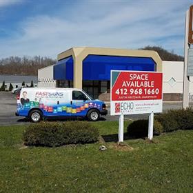 Fast sign van parked outside the building with signage