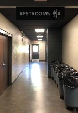 Restroom signage on the hallway