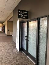 Directional sign on the wall with frosted glass