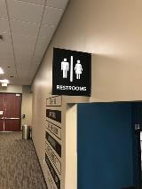 Restroom wayfinding sign on the wall