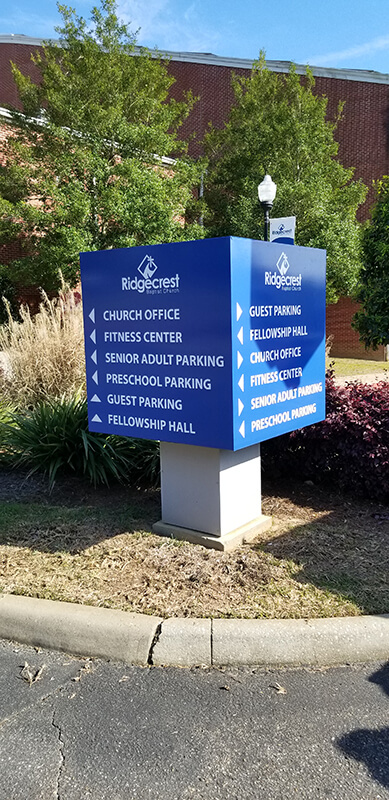 Ridgecrest directory signage on the side of the street with plants