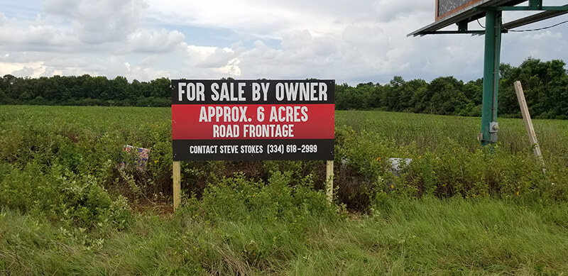 For sale by owner signage on an empty lot