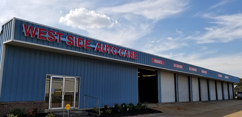 West Side Auto Carew signage on blue warehouse