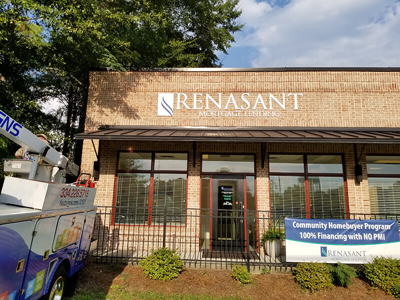 Renasant custom sign on the establishment with tow truck