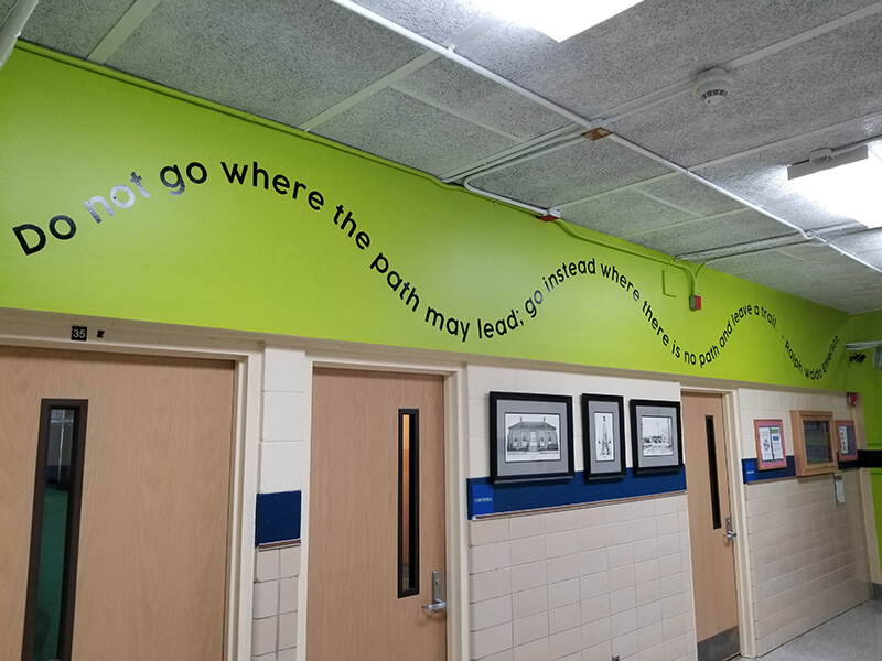 Word mural on the wall  with doors and frames below it