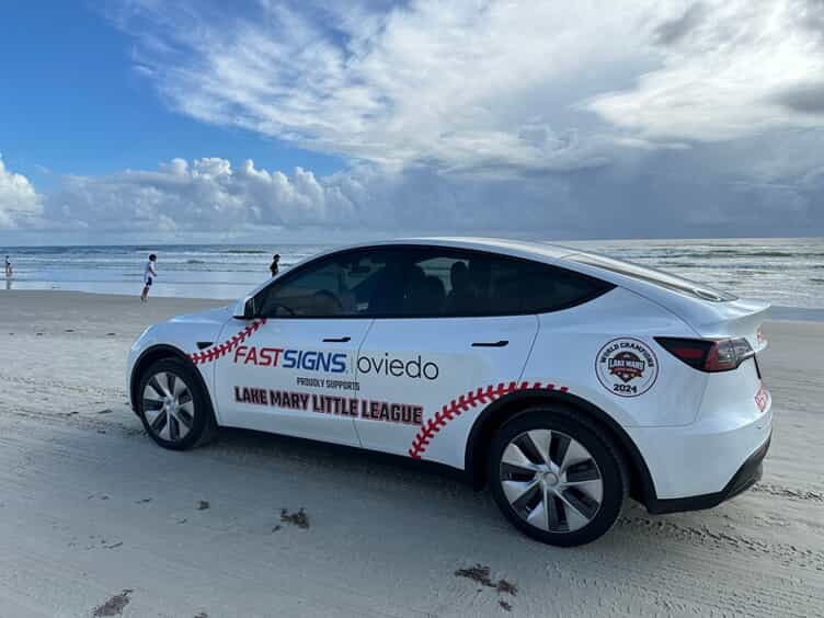 An image of a little league car wrap by FASTSIGNS.