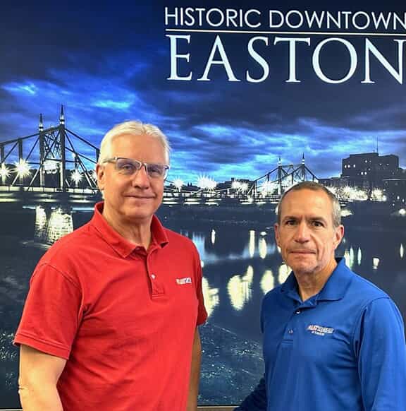 An image of two gentlemen at a sign convention.