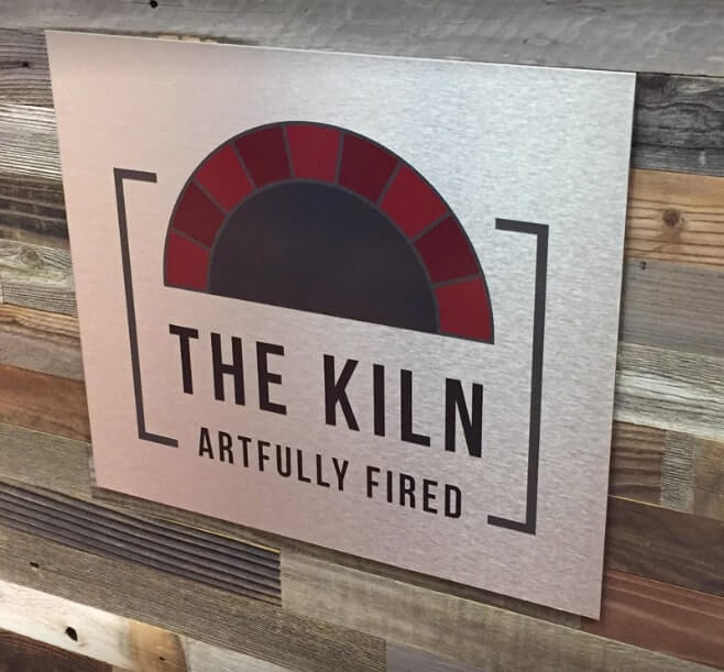 White custom decal of the Kiln on the wood wall
