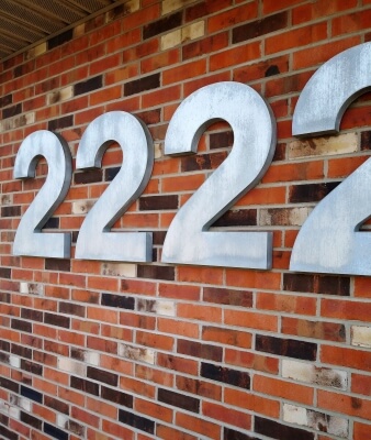 custom building address sign on brick wall