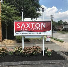 Saxton real estate signage on the side of the road